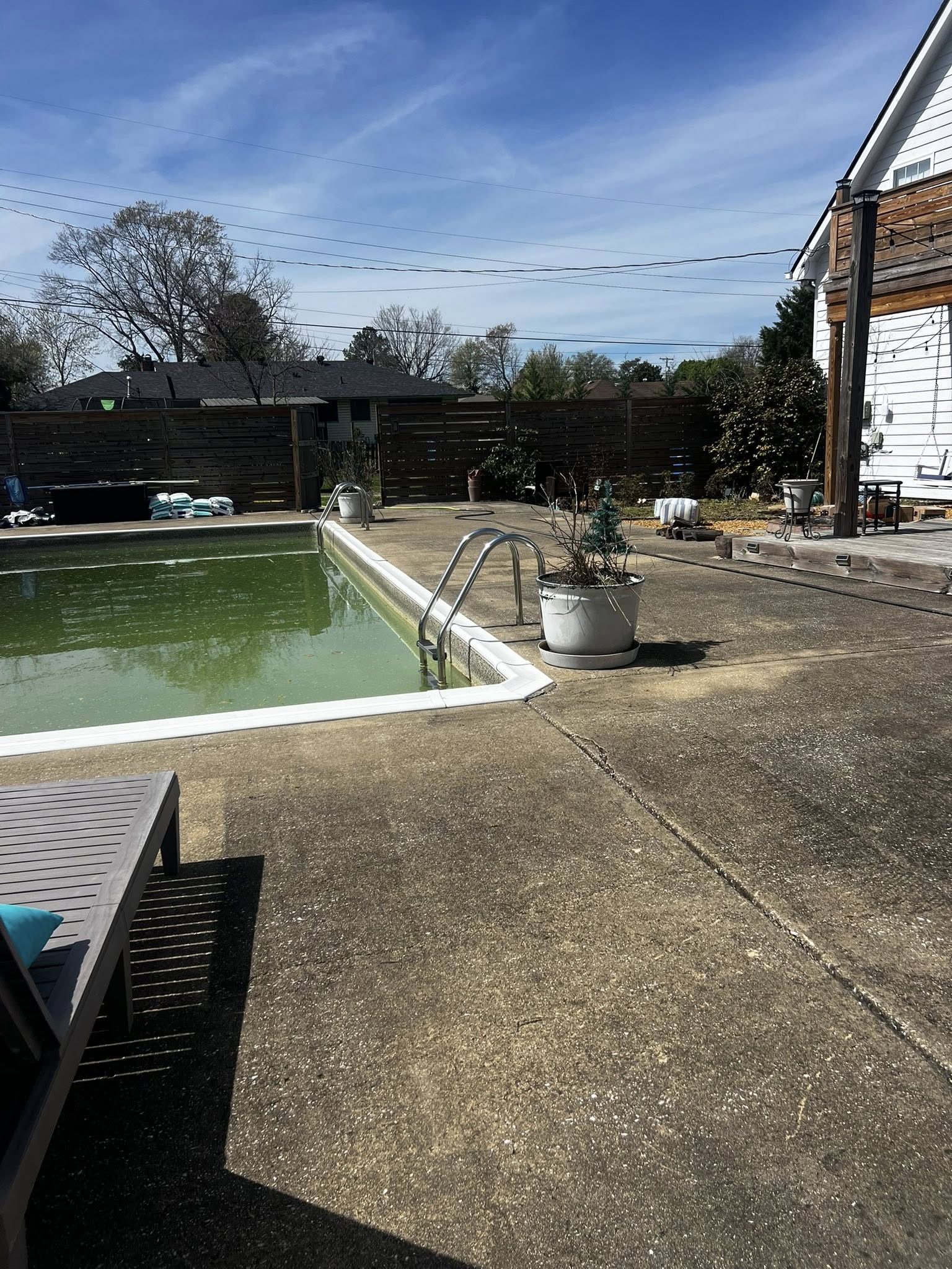 Pool deck before pressure washing — stained and dirty concrete